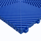 Blue plastic interlocking floor tile on a white background