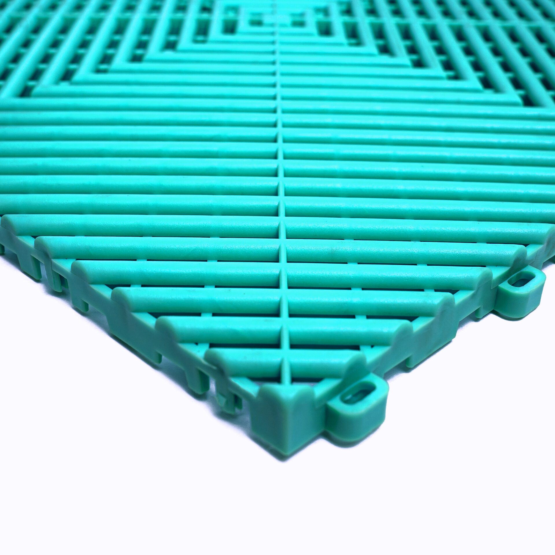 Turquoise plastic interlocking tiles on a white background